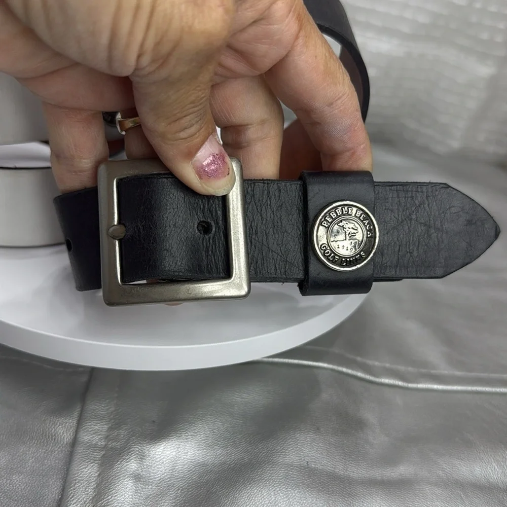 (H)Two Pebble Beach boys' leather belts with black and white metal silve buckles